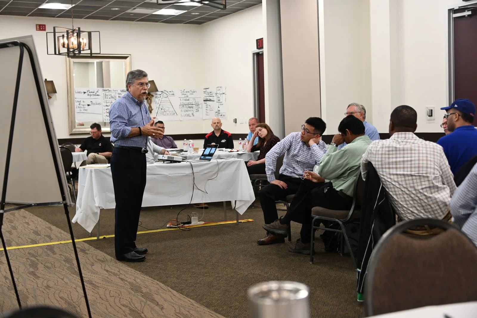 Instructor explaining a management framework at a flipchart